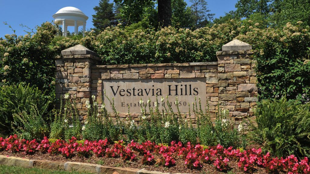 Image of a wall that has Vestavia Hills engraved on it with flowers around